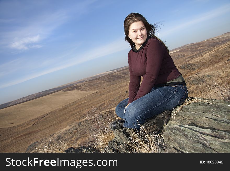 Girl Sits On Stones.