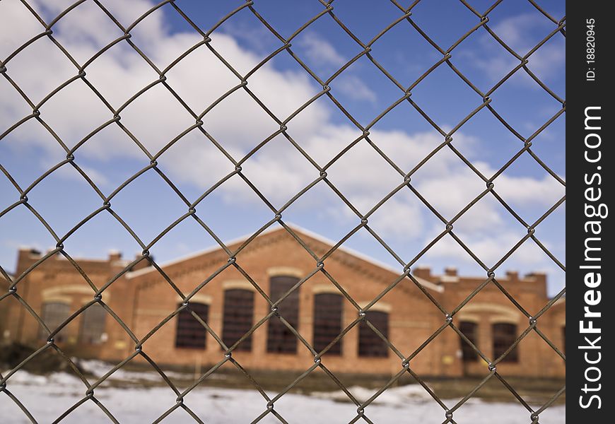 Brick Wall building behind a fence. Brick Wall building behind a fence