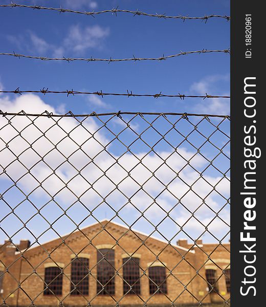 Brick Wall building behind a fence. Brick Wall building behind a fence