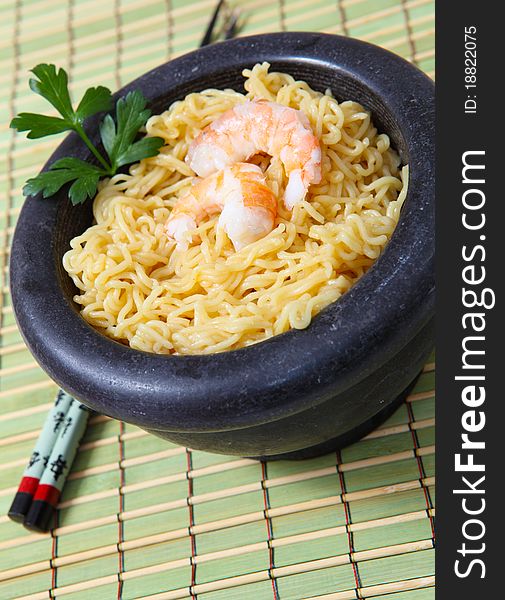 Chinese noodle with boiled prawn on wood background