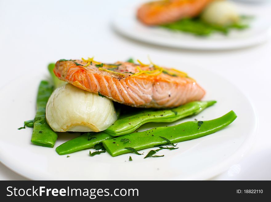 Salmon fillet with green beans and fennel on the white table