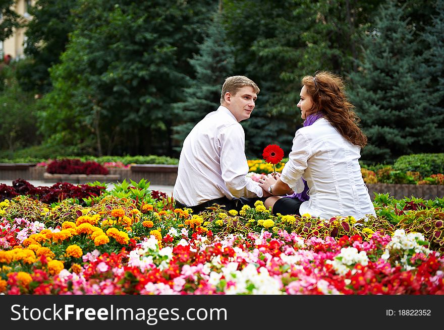 Romantic date young people in the flower park. Romantic date young people in the flower park
