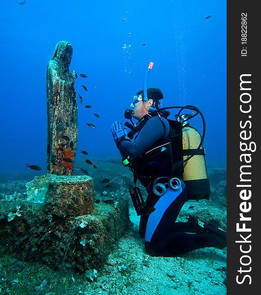 Scuba diver prying in the underwater church. Scuba diver prying in the underwater church