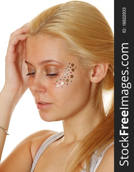 Beautiful young blond woman with makeup and multicolored crystals on the face. Beautiful young blond woman with makeup and multicolored crystals on the face