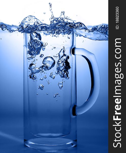 A glass of fresh water and a blue background