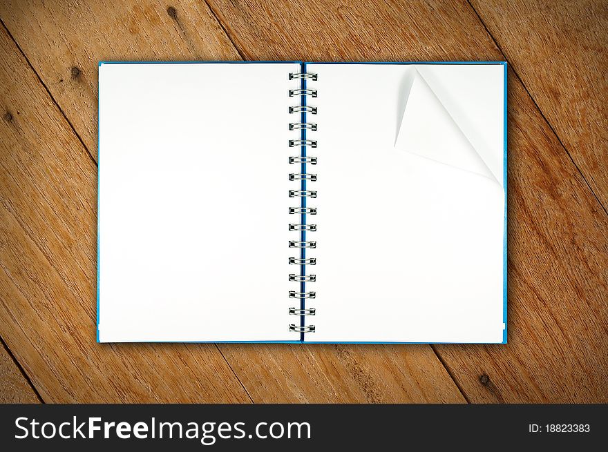 A notebook open on wood