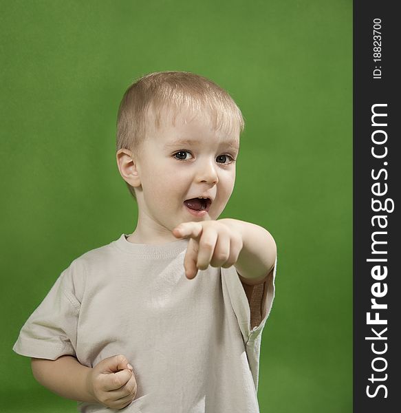 Lovely little boy on a green background