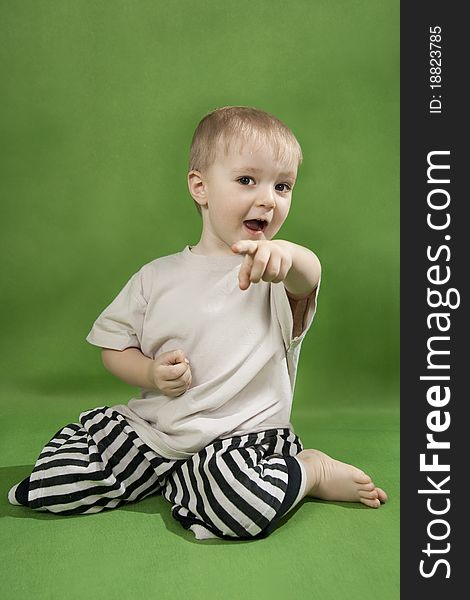 Lovely little boy on a green background