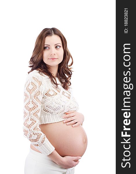 Studio portrait of pregnant curious woman holding her belly with hand