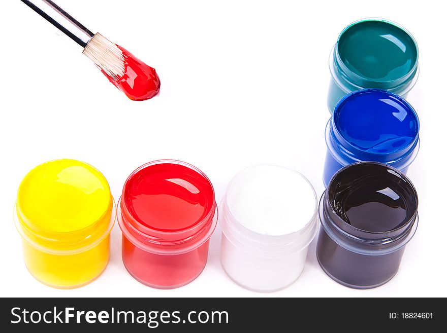 Six cans of acrylic paints with a paint-brush in red. Six cans of acrylic paints with a paint-brush in red