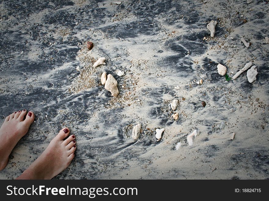 Two feet on a coral sand beach. Two feet on a coral sand beach