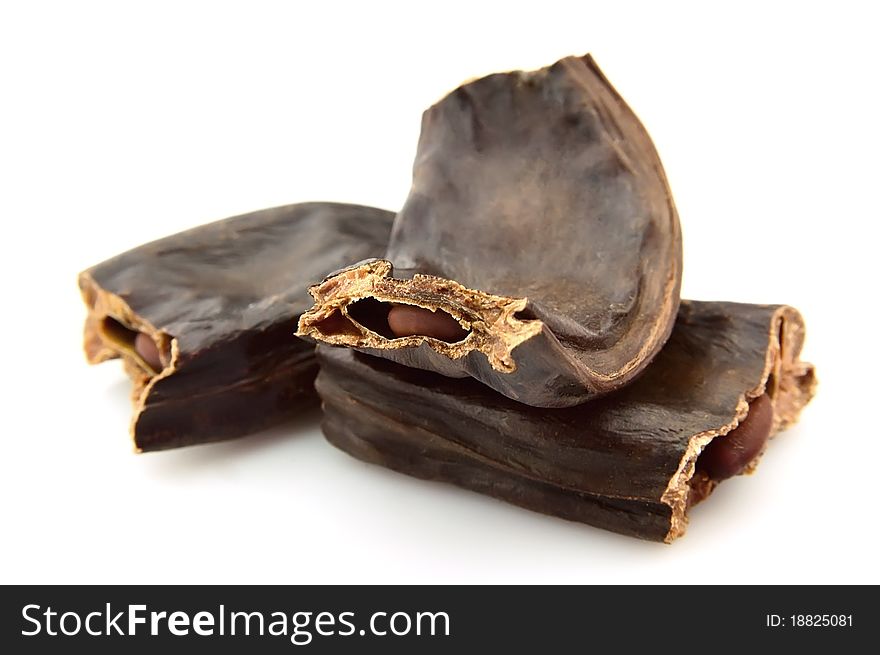 Carob pods on a white background