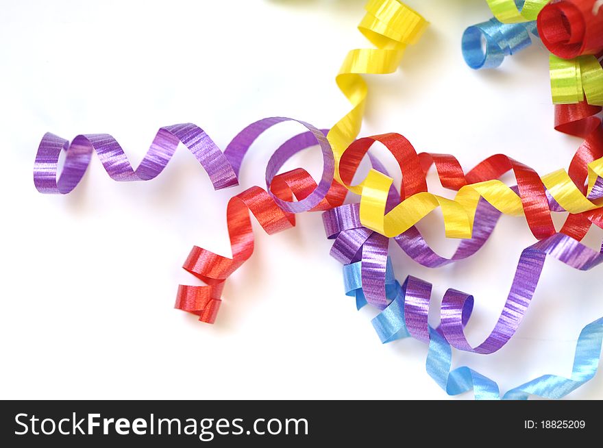 Colorful ribbons curled up on white space