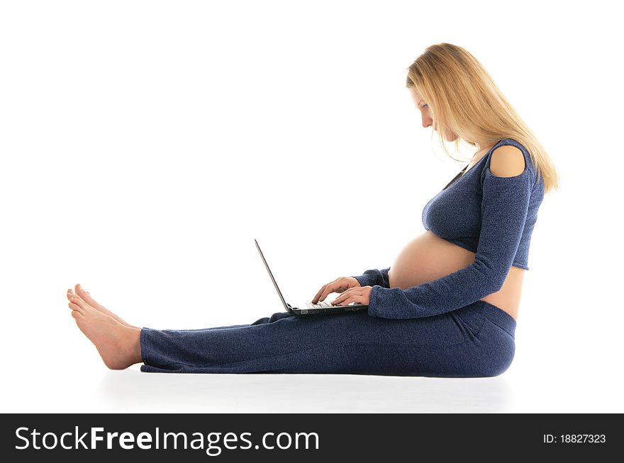 Pregnant Woman With A Laptop Sitting On The Floor