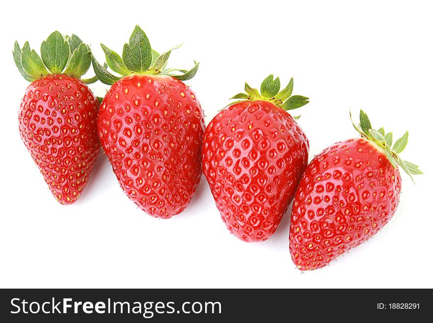 Four fresh strawberries isolated on white background.