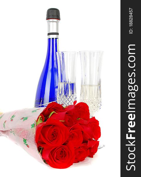 Champagne and roses for celebration of Valentines day with blue bottle in background