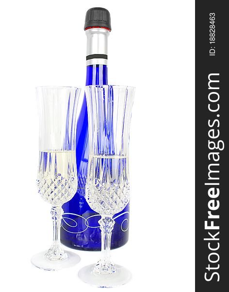 Champagne set with blue bottle and two crystal glasses isolated on the white background. Champagne set with blue bottle and two crystal glasses isolated on the white background.
