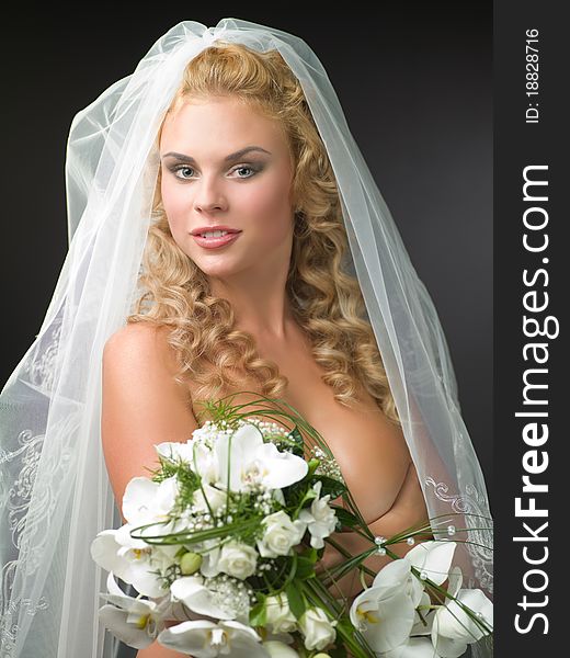 Woman In A Veil Bride With A Bouquet Of Flowers