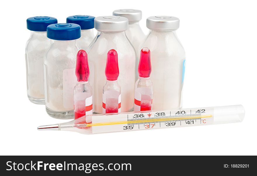 Ampoule, a thermometer and pills on a white background