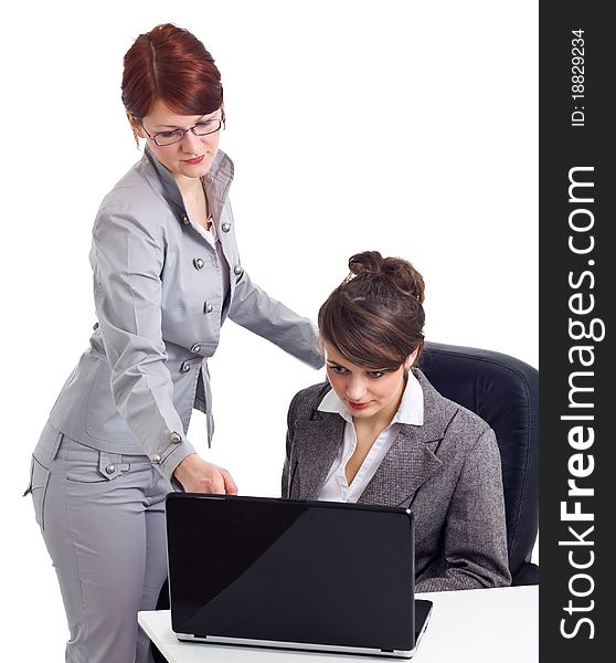 Two young businesswoman with laptop isolated over white