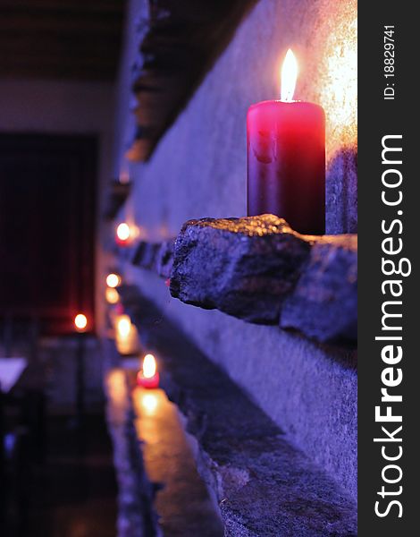 A red candle standing on the stone as a part of restaurant design. A red candle standing on the stone as a part of restaurant design