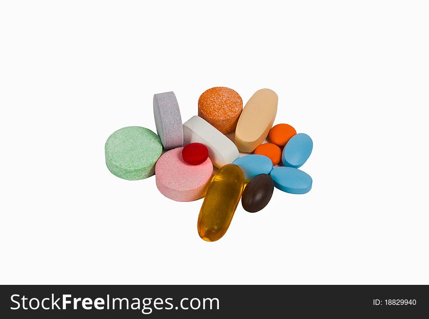 Different colorful pills with capsules on the white background.