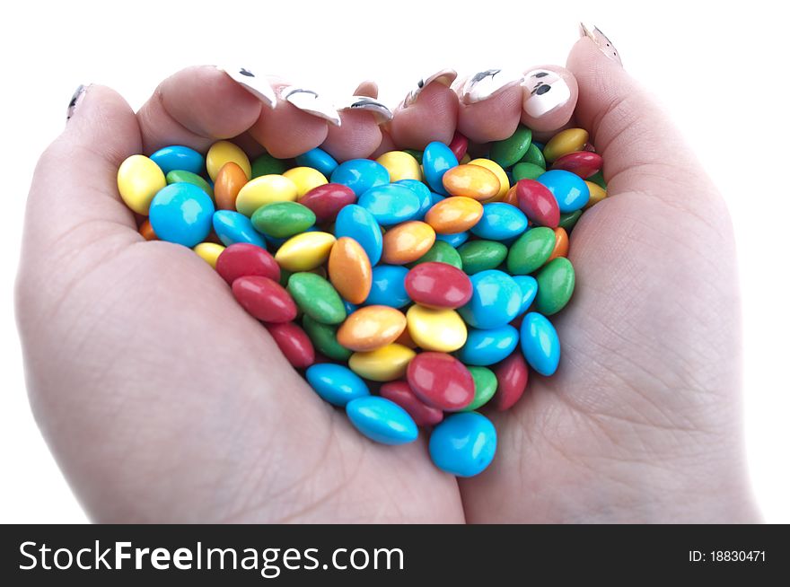 Colored candies in hands isolated on a white background