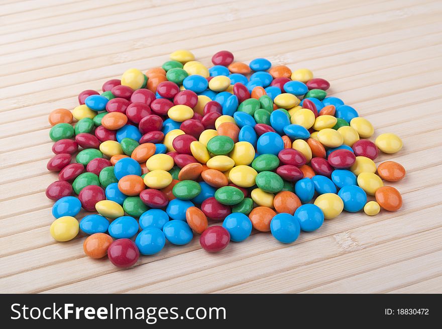 Many colored candy on a wooden table. Many colored candy on a wooden table