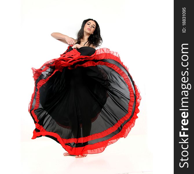 Studio portrait of young attractive woman dancing flamenco