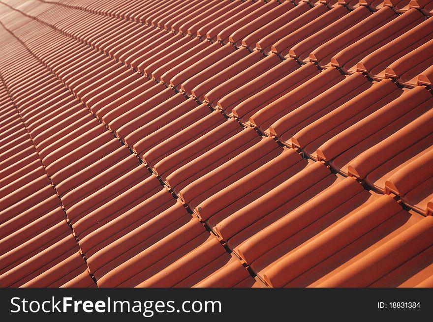 Skew view of a red roofing tile rooftop