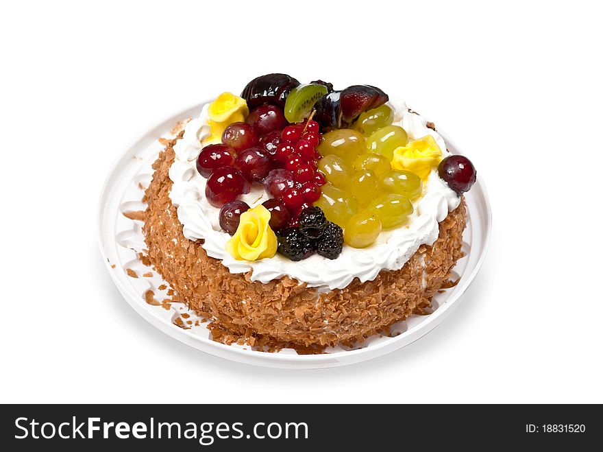 Cake with fruits and whipped cream on plate. Isolated on white. Cake with fruits and whipped cream on plate. Isolated on white