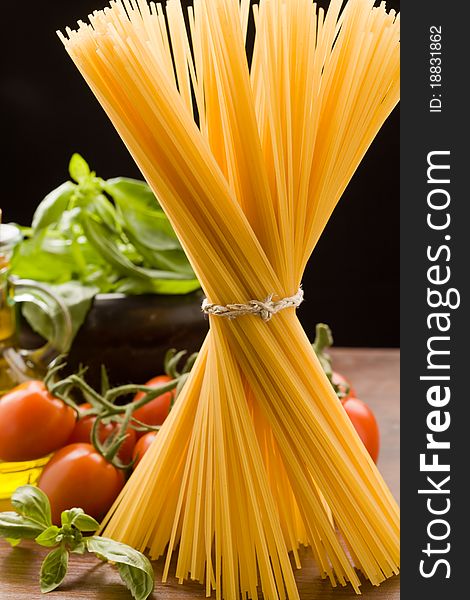 Photo of different ingredients for italian pasta with tomatoes and basil