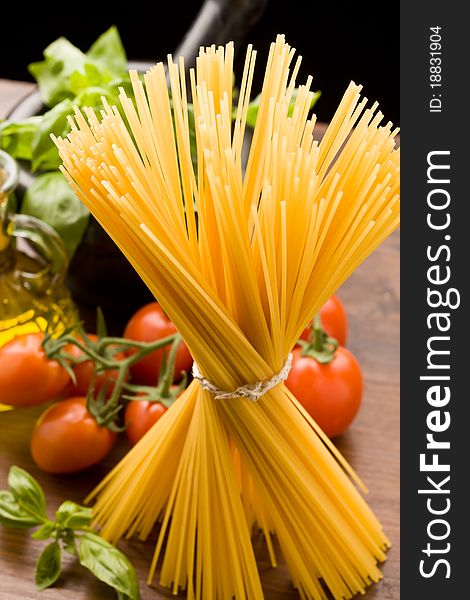 Photo of different ingredients for italian pasta with tomatoes and basil