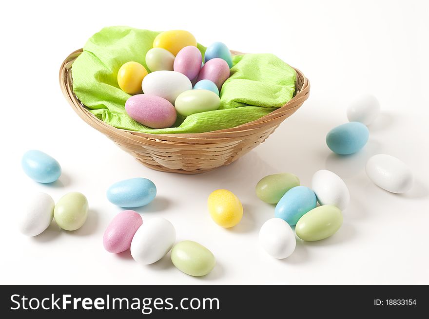 Easter, basket with almonds on white background