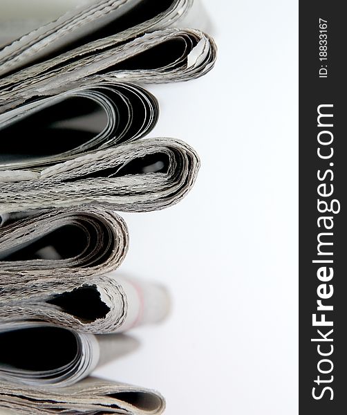 Stack of daily newspapers in white background