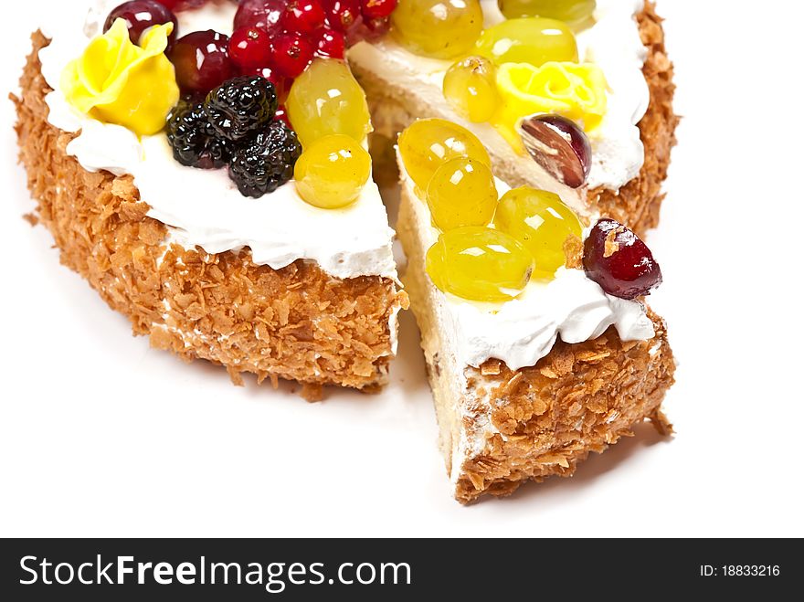 Cake with fruits and whipped cream. Isolated on white background