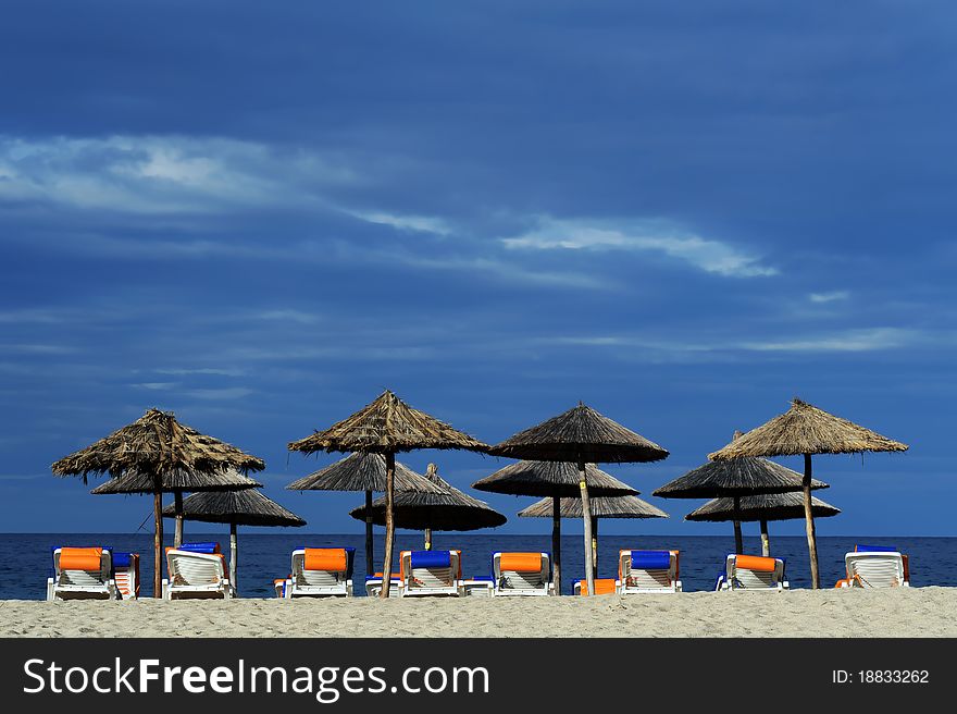 Decks and umbrella on beach in Toronii, Sithonia, Greece