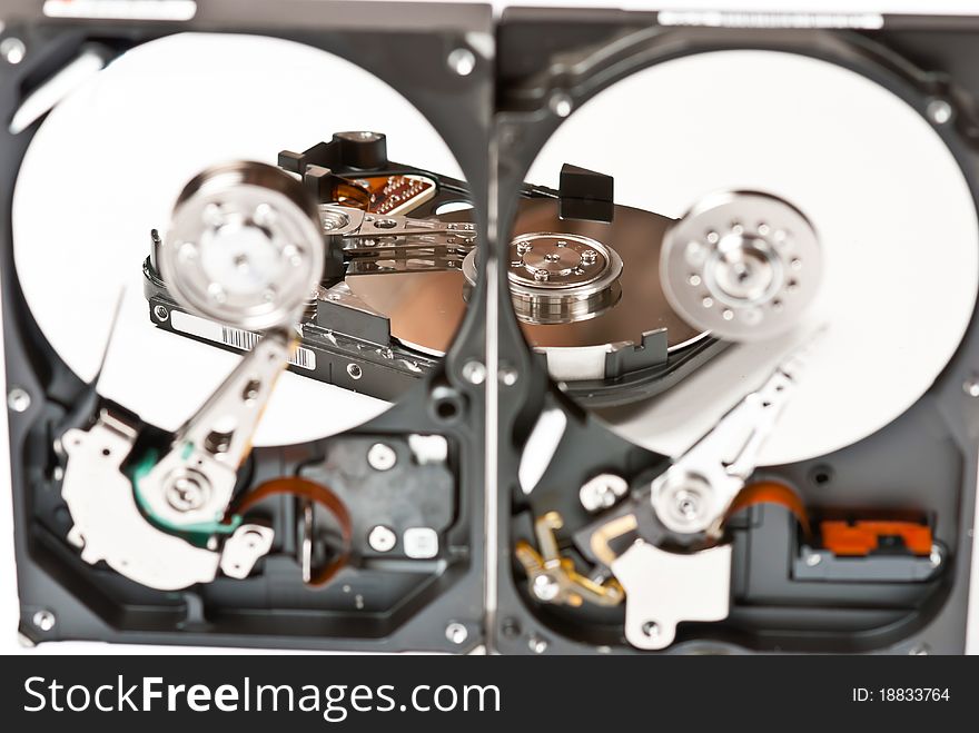 Opened hard disks on white background. Studio shot