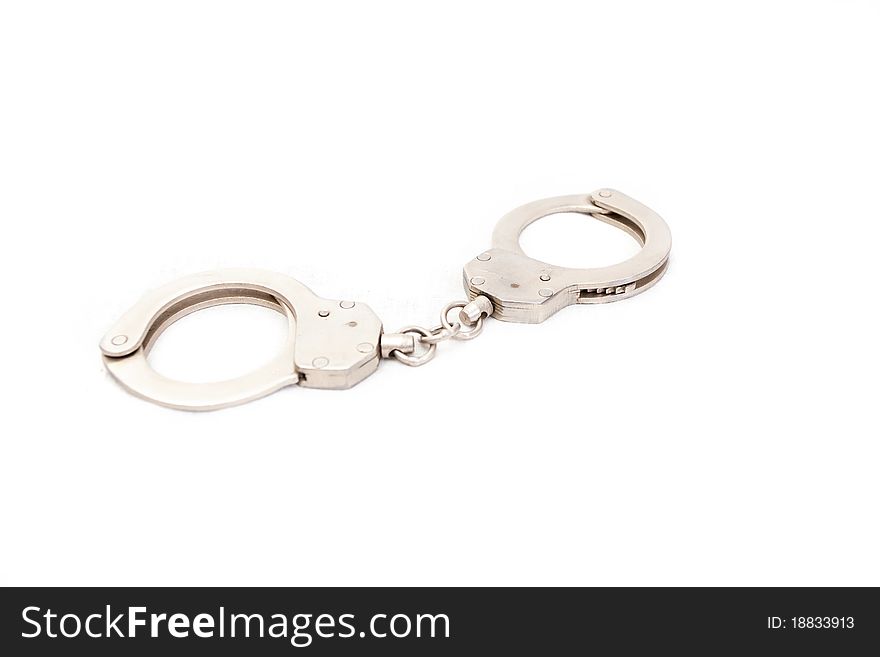 The clasped handcuffs on a white background