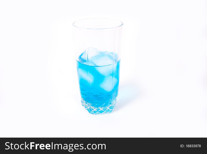 Transparent glass with a blue drink and ice. Transparent glass with a blue drink and ice