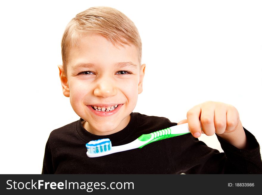 The boy brushes teeth a brush on a white background