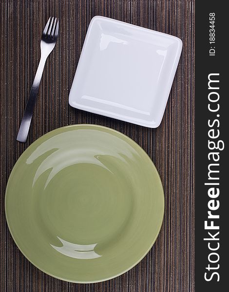 Ceramic plates for table on a brown background. Ceramic plates for table on a brown background.