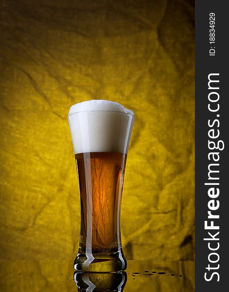 Beer In Glass  On Yellow Background