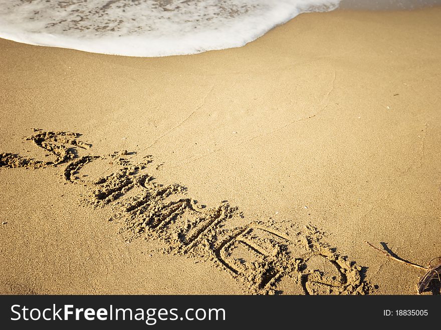 Word summer written on sand