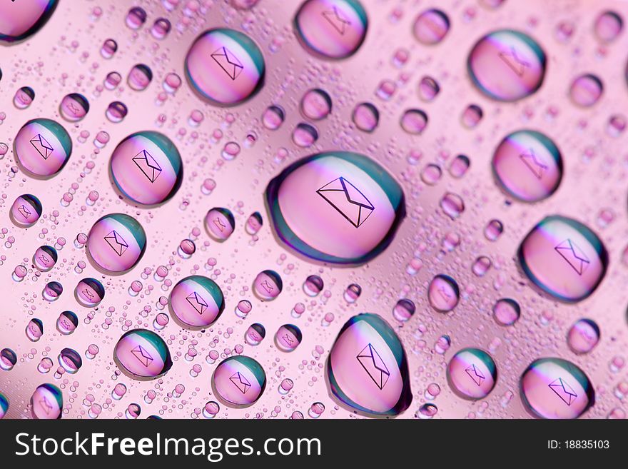 Envelope symbol reflected in the drops of water. Close-up of water droplets placed on a DVD disc. Envelope symbol reflected in the drops of water. Close-up of water droplets placed on a DVD disc.