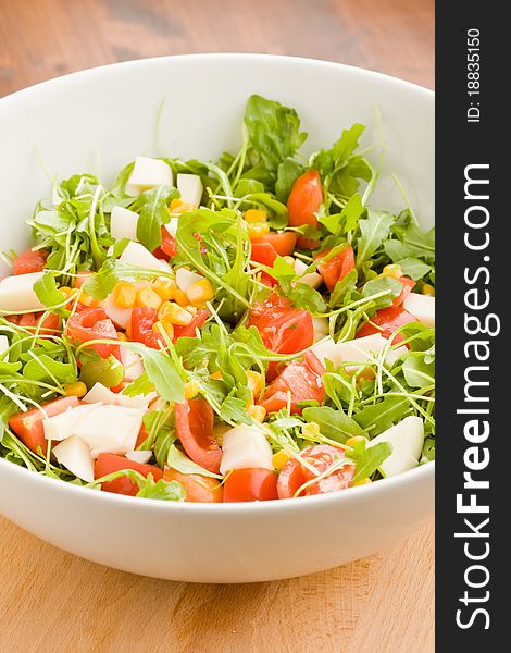 Photo of delicious rocket salad with tomatoes and mais. Photo of delicious rocket salad with tomatoes and mais