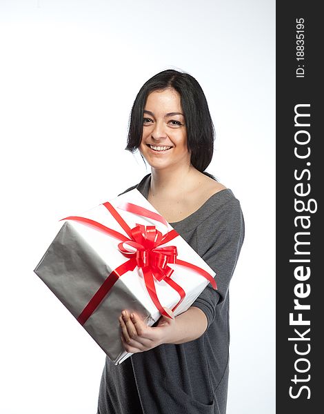 Portrait of young smiling woman with gift