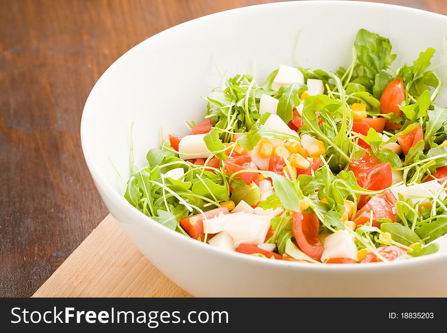 Photo of delicious rocket salad with tomatoes and mais. Photo of delicious rocket salad with tomatoes and mais