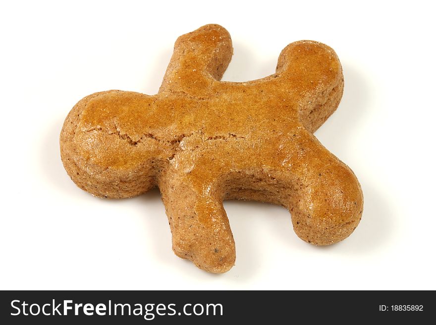Gingerbread man lying over white