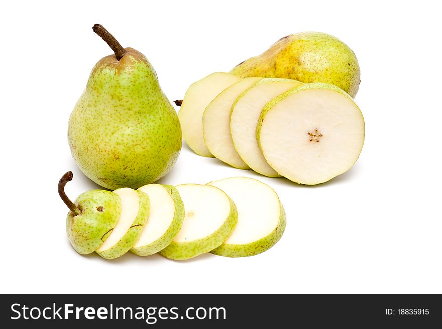 Two pears and slices of a pear over white background